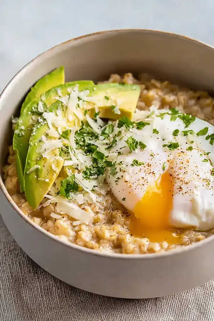 Simple Savory Avocado Oatmeal with runny egg and creamy oats close-up