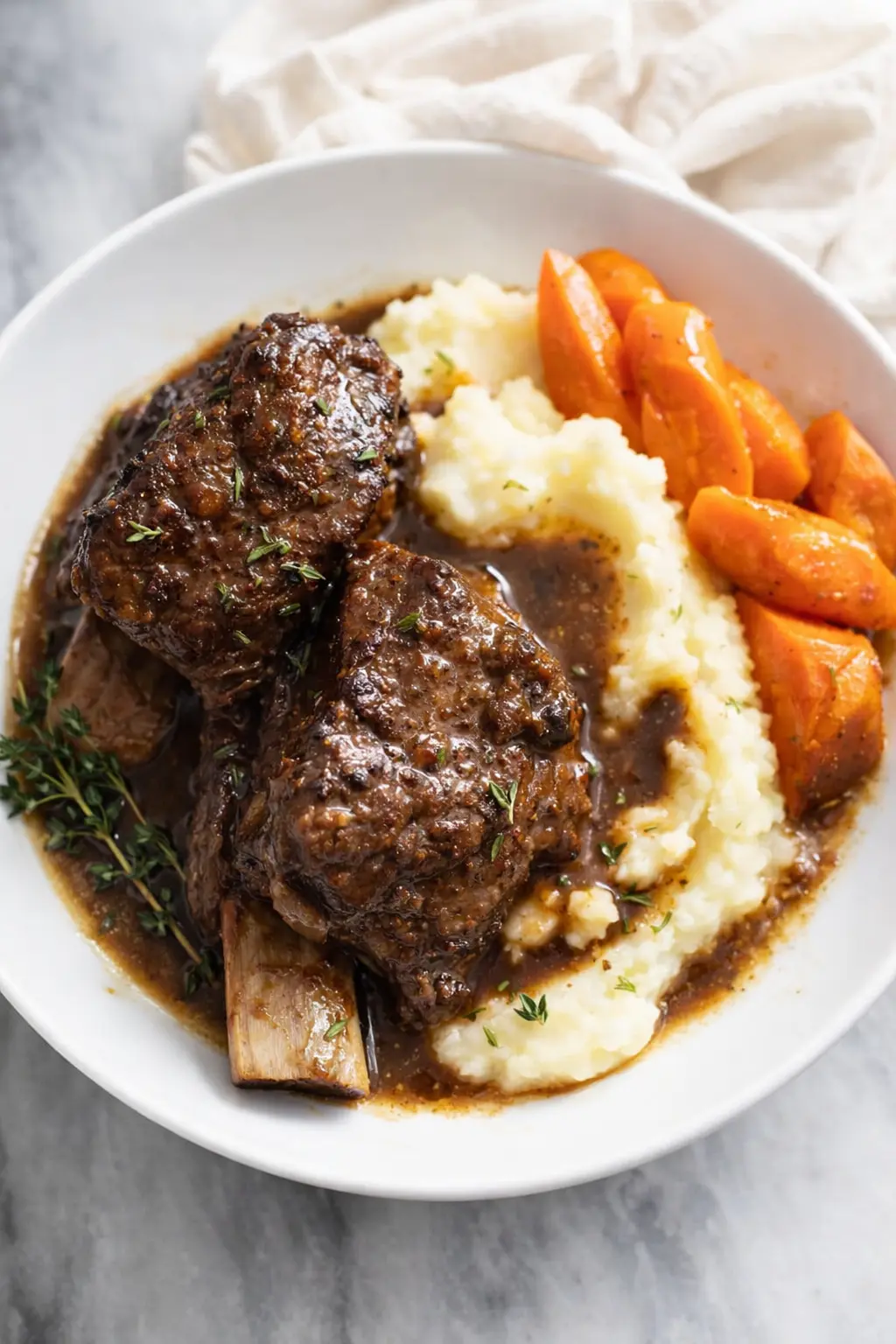 Slow cooker short ribs with mashed potatoes, carrots, and rich brown sauce