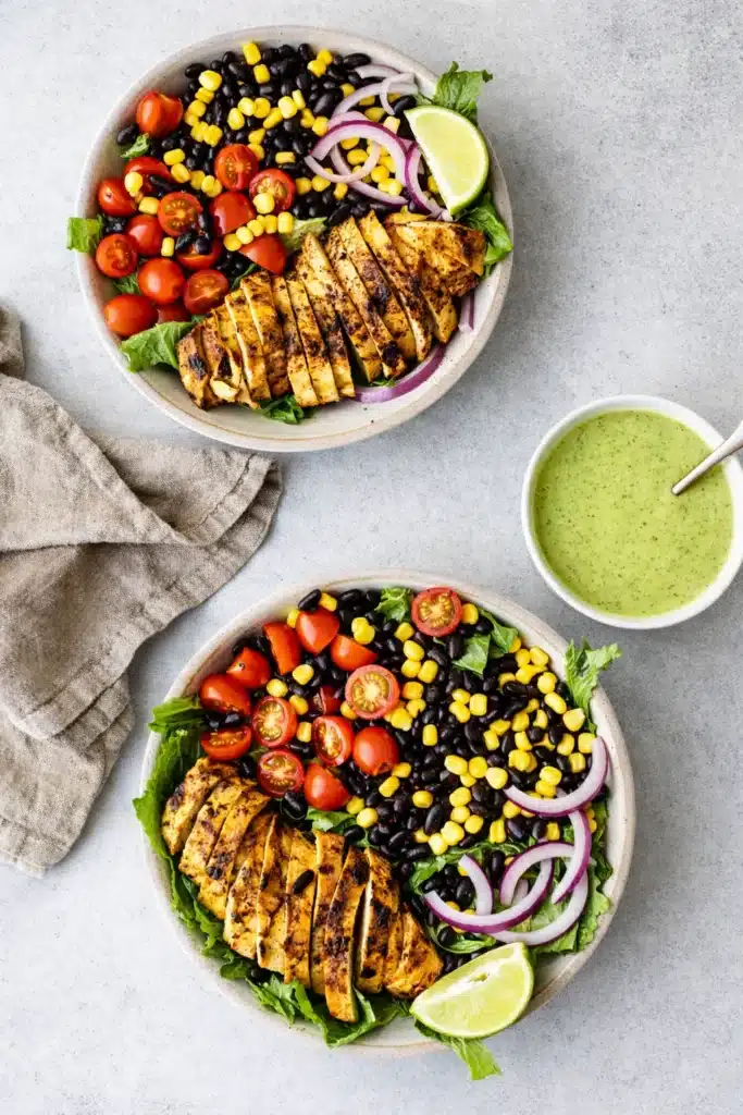 Southwest chicken salad bowls with grilled chicken, corn, beans, and fresh vegetables