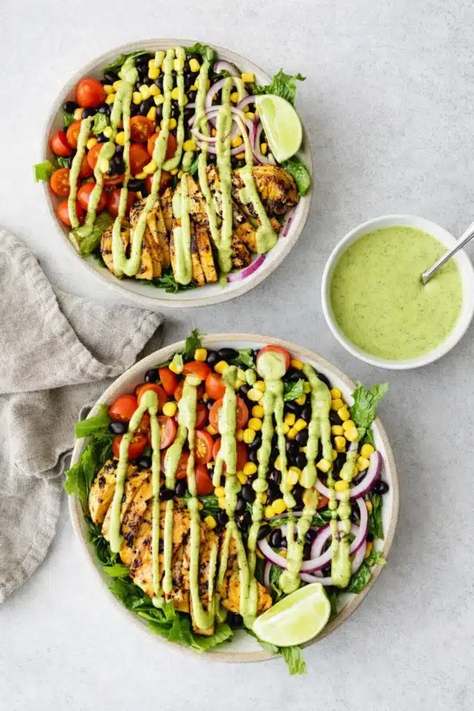 Southwest chicken salad with grilled chicken, avocado dressing, corn, beans, and fresh vegetables