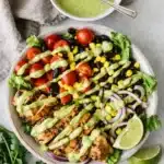 Southwest chicken salad with avocado dressing, grilled chicken, corn, beans, and fresh vegetables