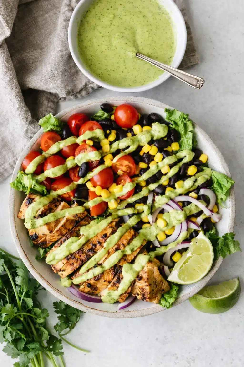 Southwest chicken salad with avocado dressing, grilled chicken, corn, beans, and fresh vegetables