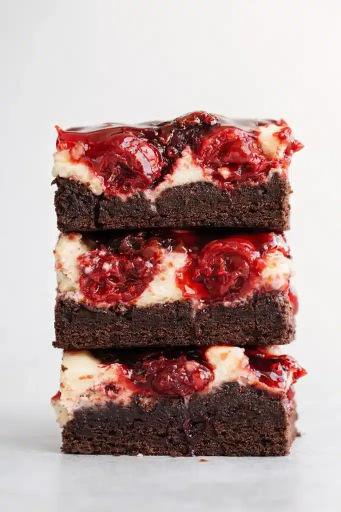 Stacked Cherry Cheesecake Brownies with fudgy chocolate layers and glossy cherry topping