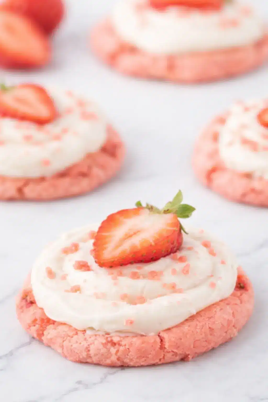 Strawberry cheesecake cookies with cream cheese frosting and fresh strawberry topping