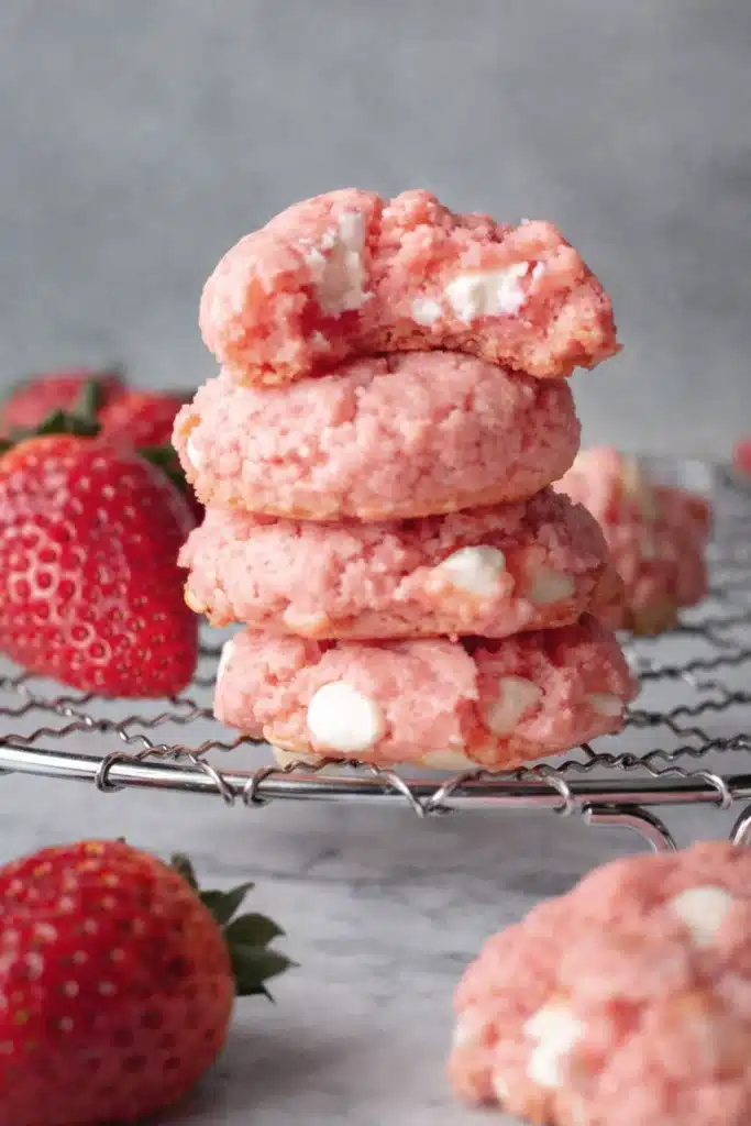Strawberry Cheesecake Cookies Recipe Easy Amazing Treat 8 strawberry cheesecake cookies with white chocolate chips stacked on cooling rack