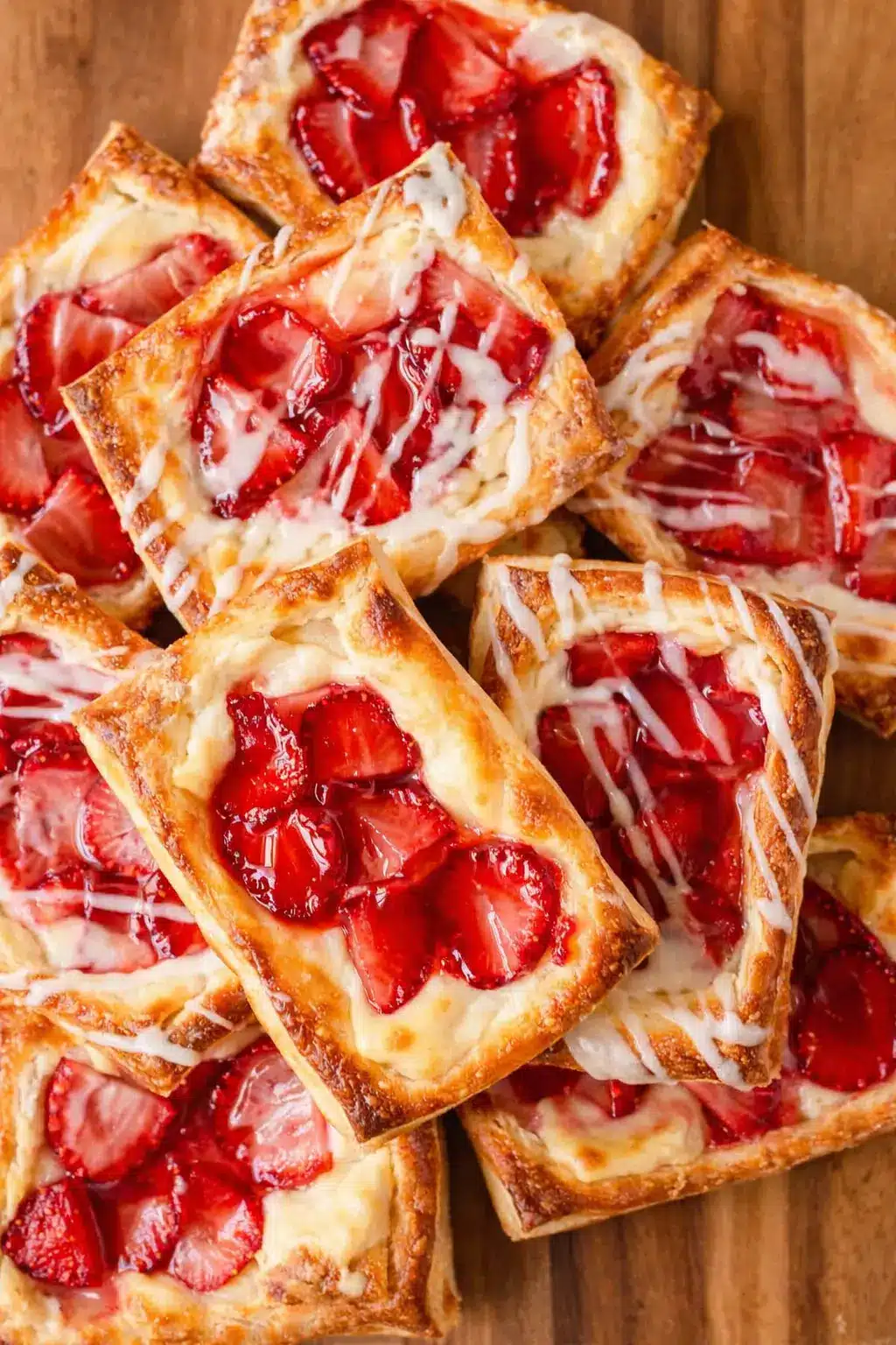 Strawberry danish pastries with cream cheese filling and glossy fresh strawberries
