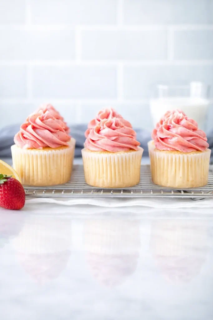Strawberry Lemonade Cupcakes Amazing Fresh Treat 5 Strawberry Lemonade Cupcakes with pink frosting on cooling rack