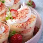 Strawberry shortcake pudding cups with whipped cream and fresh strawberries in clear dessert cups
