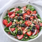 Strawberry Spinach Salad with Feta Fresh Easy Favorite 7 Strawberry spinach salad with feta, blueberries, pecans, and balsamic dressing in a white bowl