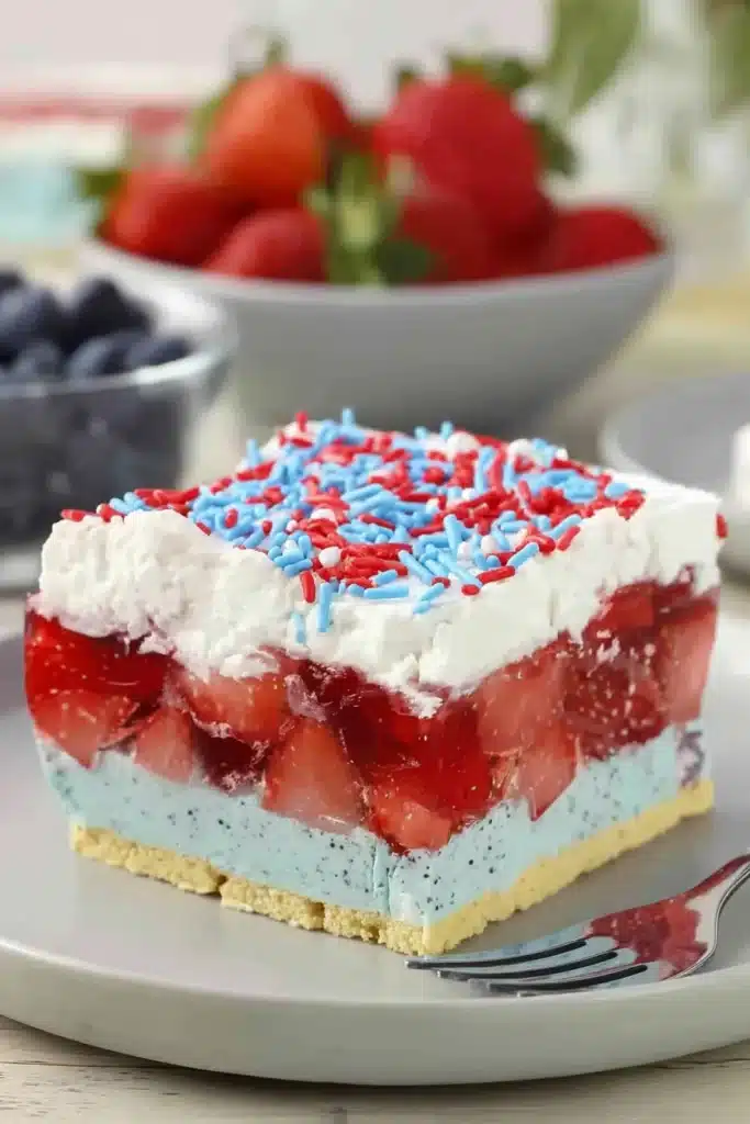 Summer Berry Jello Lasagna slice with strawberry gelatin and creamy blue layer