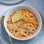 White Chicken Chili Recipe Easy Creamy Comfort Meal 7 Creamy white chicken chili with tortilla strips and lime in a bowl