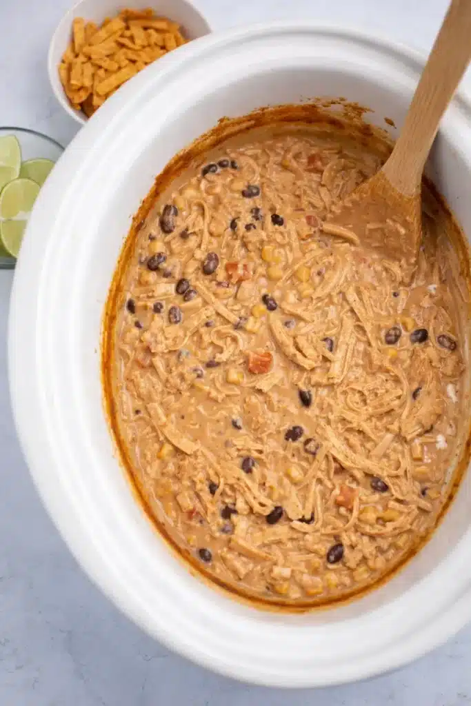 White Chicken Chili Recipe Easy Creamy Comfort Meal 5 White Chicken Chili Recipe cooking in a slow cooker with shredded chicken and beans