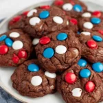 4th of July cookies with chocolate base and red white blue candy on plate
