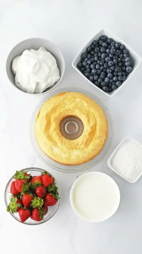 Ingredients for 4th Of July Berry Trifle with angel food cake, berries, pudding, and whipped topping