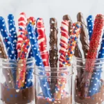 4th of July chocolate covered pretzel rods with patriotic candy coating and festive sprinkles