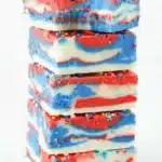 4th of July fudge squares with red white and blue swirls and patriotic sprinkles