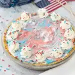 4th of July ice cream pie with red white and blue swirls and whipped cream topping