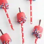 4th Of July Marshmallow Pops with patriotic sprinkles on striped paper straws