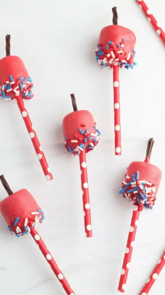 4th Of July Marshmallow Pops with patriotic sprinkles on striped paper straws