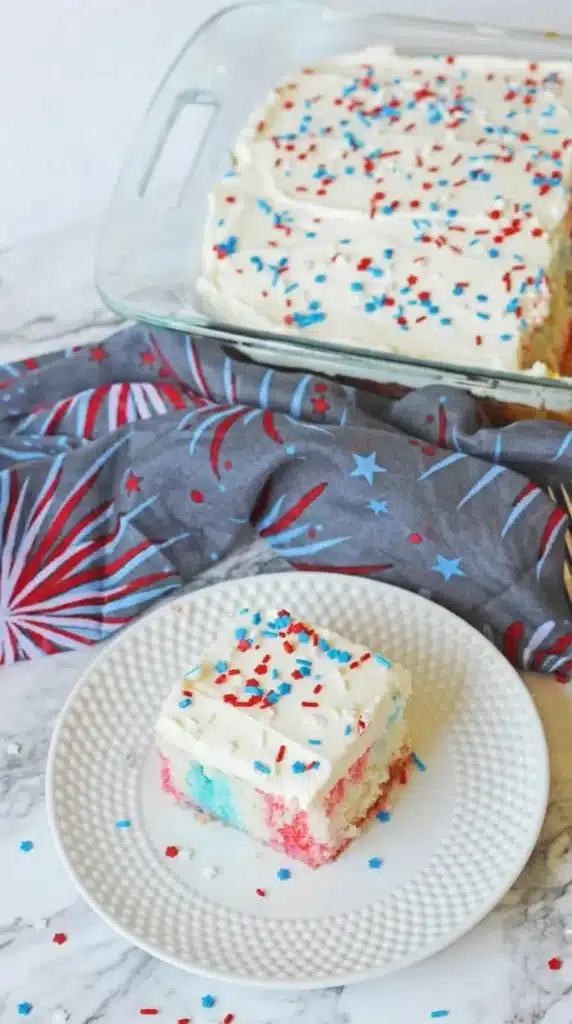 4th Of July Poke Cake Recipe slice with patriotic sprinkles and full cake in baking dish