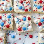 4th of July sugar cookie bars with vanilla frosting and patriotic sprinkles