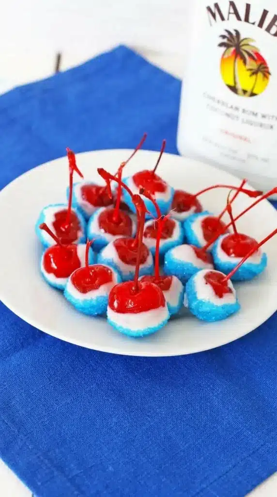 Boozy Cherry Bombs dipped in white chocolate with blue sugar coating