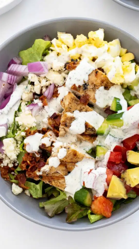 Chicken Cobb Salad with grilled chicken, eggs, avocado, bacon, and creamy ranch dressing