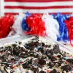 No bake Oreo cheesecake bars with sprinkles and crushed cookies in a baking dish