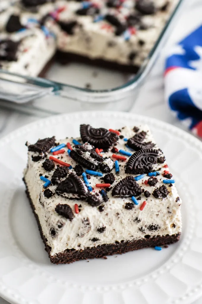 No Bake Fireworks Oreo Cheesecake Bars slice with sprinkles on plate