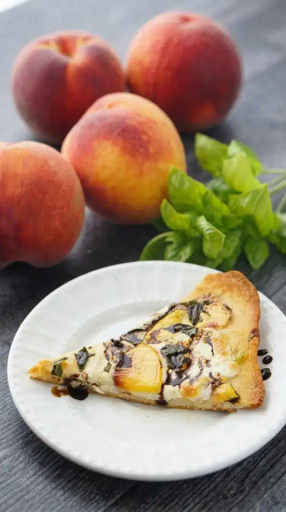 Slice of Peach & Basil Naan Bread Pizza with balsamic glaze