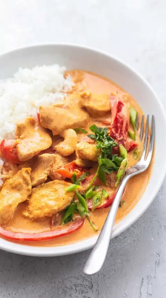 Thai Chicken Curry with Coconut Milk served with rice in a white bowl