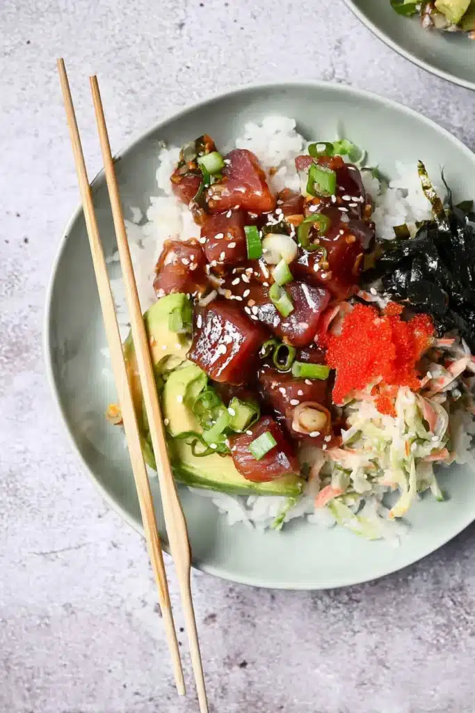  Full ahi tuna poke bowl with sushi rice, avocado, seaweed, and sesame seeds