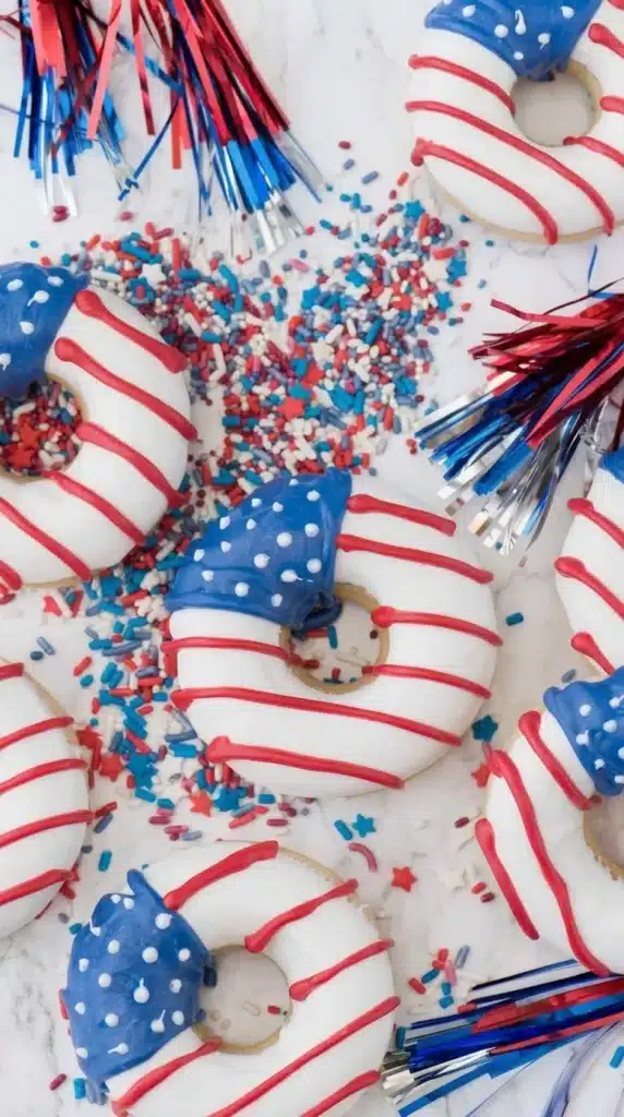 American Flag Donuts with patriotic sprinkles and festive 4th of July decorations