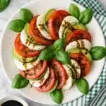 Avocado Caprese Salad Easy Amazing Summer Favorite 7 Avocado Caprese Salad with mozzarella, tomatoes, basil, and balsamic glaze on a ceramic plate