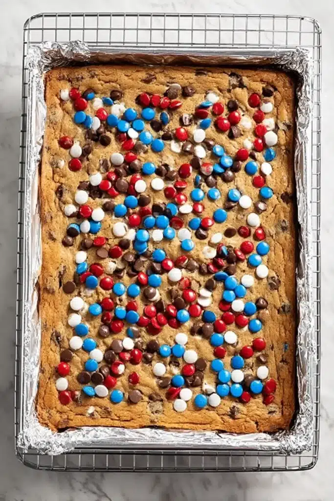 Freshly baked Red, White and Blue M&M’S Cookie Bars in baking pan