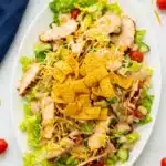 BBQ chicken salad with grilled chicken, lettuce, cheese, ranch dressing, and crunchy tortilla strips