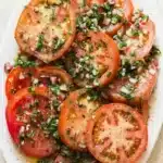 The Best Marinated Tomatoes Salad Easy Amazing Lunch 11 Fresh marinated tomato salad with herbs, onions, and olive oil dressing on a ceramic serving platter