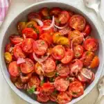 The Best Summer Cherry Tomato Salad That Tastes Amazing 11 Fresh summer cherry tomato salad with basil and red onion in a rustic bowl
