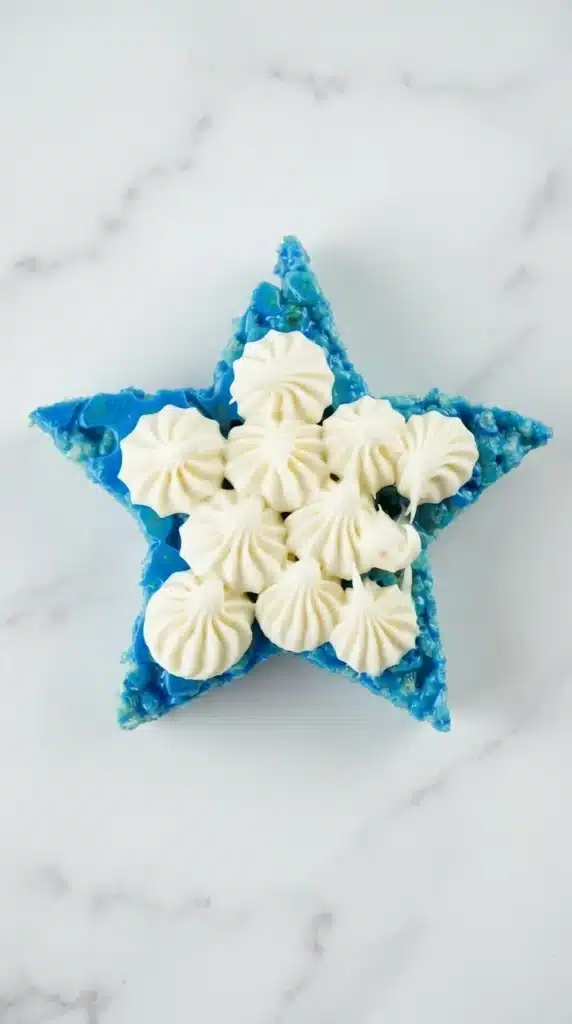 4th Of July Rice Krispie Treats That Everyone Loves 11 4th Of July Rice Krispie Treats with piped vanilla frosting on blue star treats