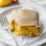 Brown Sugar Peach Cake slice with creamy frosting and fresh peach filling