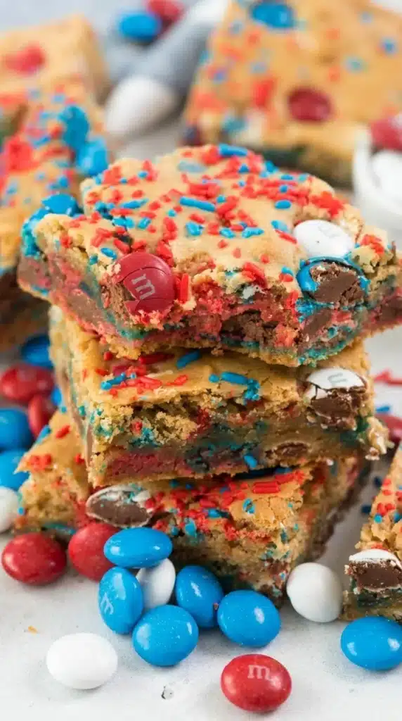 Chewy Fireworks Blondies stacked with patriotic candies and sprinkles