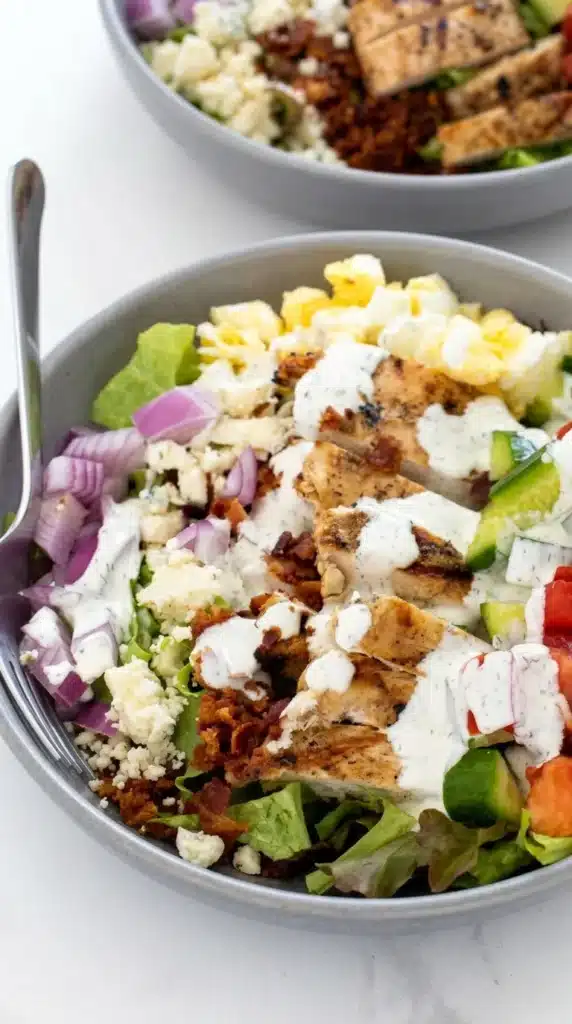 Chicken Cobb Salad with ranch dressing poured over grilled chicken and fresh vegetables