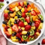Classic Fruit Salad Recipe That Tastes Amazing 11 Classic fruit salad with strawberries, kiwi, pineapple, grapes, and blueberries in a white serving bowl