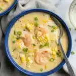Creamy shrimp and corn soup with shrimp, sweet corn, and green onions in a rustic bowl