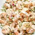 Creamy shrimp salad with lemon dill dressing, celery, and red onion in a ceramic bowl