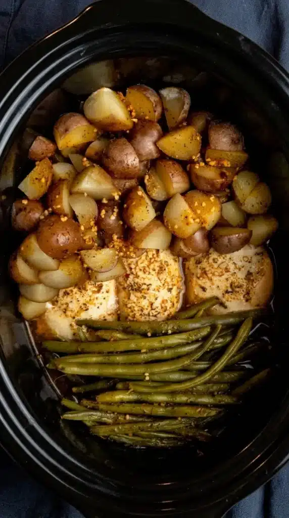 Crock Pot Chicken Potatoes and Green Beans cooking in a slow cooker