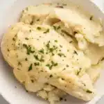 Creamy Crockpot Boursin Chicken with mashed potatoes and garlic herb sauce