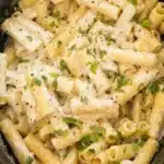 Crockpot Chicken Alfredo Recipe for Creamy Weeknight Comfort 5 Creamy Crockpot Chicken Alfredo with rigatoni pasta and shredded chicken in parmesan sauce