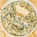 Creamy crockpot spinach artichoke dip served with crispy tortilla chips