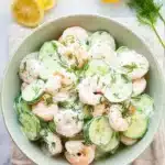 Cucumber shrimp salad with creamy lemon dill dressing and fresh cucumbers in a ceramic bowl
